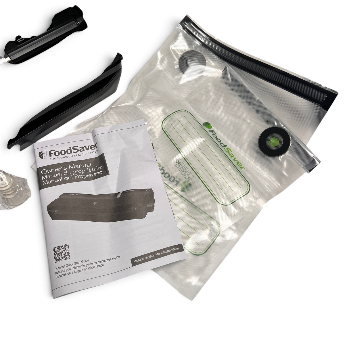 WT Outlets open box Foodsaver 2-in-1 vacuum sealer accessories including two storage bags and owner manual