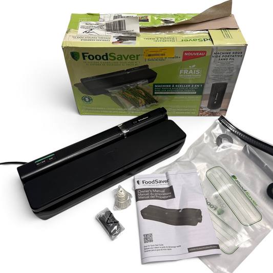 WT Outlets Foodsaver 2-in-1 vacuum sealing system in black with included bags, manual, and original packaging.