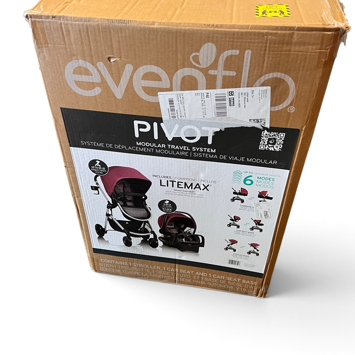WT Outlets Evenflo Pivot modular travel system in dusty rose inside a cardboard shipping box