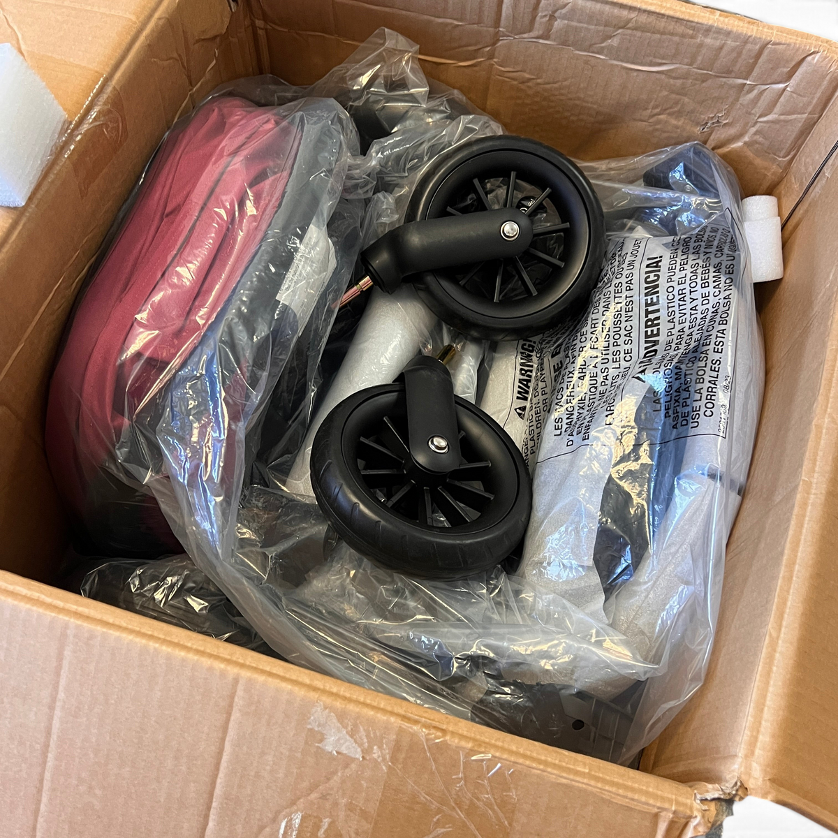 WT Outlets Evenflo Pivot travel system in dusty rose packed in a new open box with stroller frame and wheels