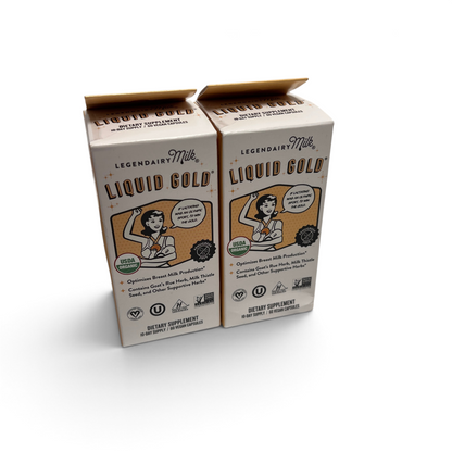 Two boxes of WT Outlets Legendairy Milk Liquid Gold lactation supplement capsules for breast milk production.